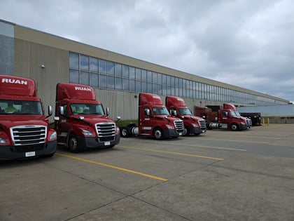 photo of semi trucks lined up in parking lot