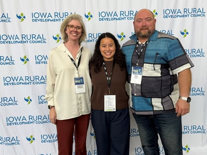 Bess, Nate, and Anastasia group photo at conference