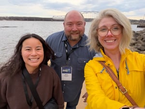 Bess, Nate, and Anastasia group photo in front of river