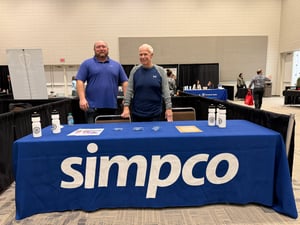Nate and Bob standing next to simpco booth at siouxland mental wellness expo