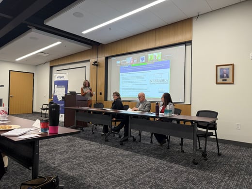 Tourism Panel sitting at table speaking to audience